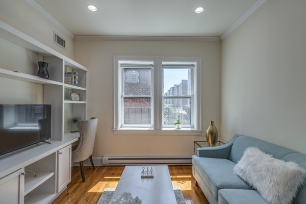 15 Garrison Street, Unit 9 Boston, MA 02116 - Photo 3 of 18 a living room with furniture and a flat screen tv