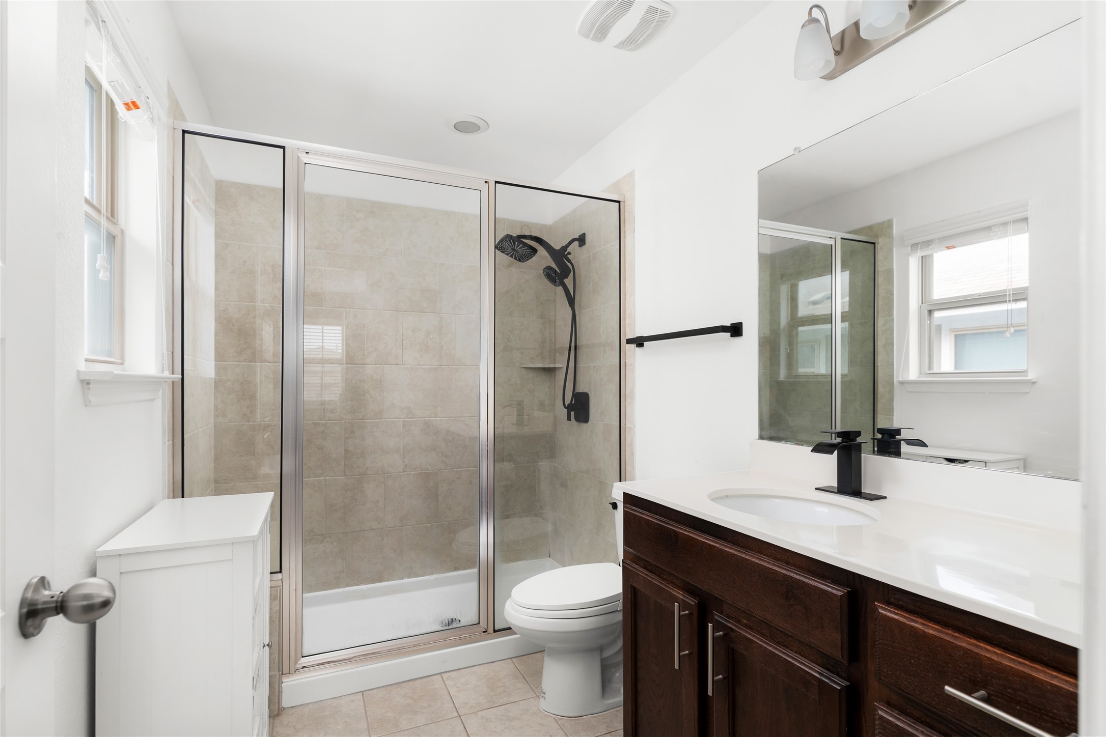 249 Wapiti Road Buda, TX 78610 - Photo 14 of 21 A pristine bathroom featuring a contemporary glass-enclosed shower alongside a stylish vanity.