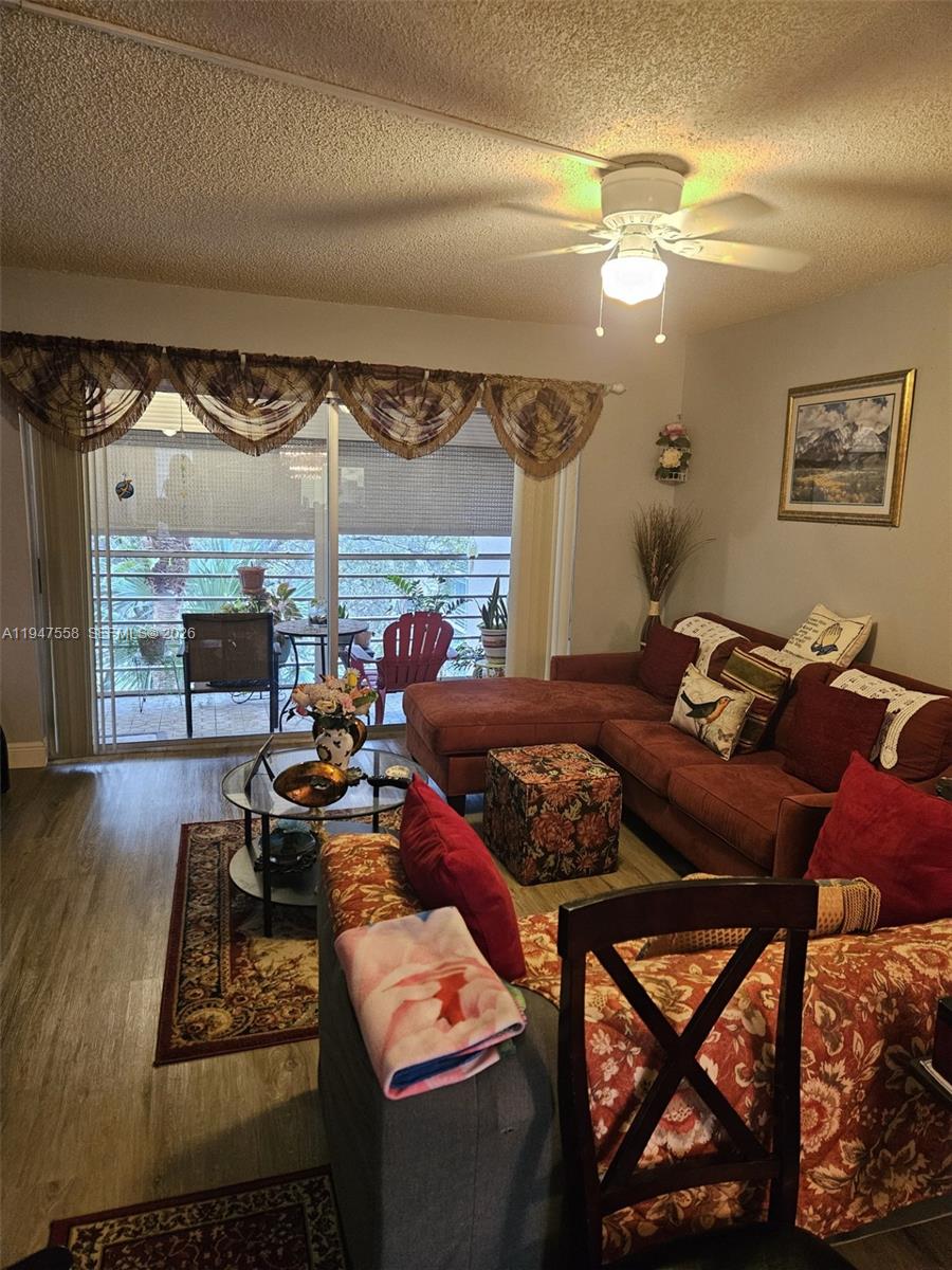 3591 Inverrary Drive, Unit 405 Lauderhill, FL 33319 - Photo 2 of 9 a living room with furniture and a fireplace