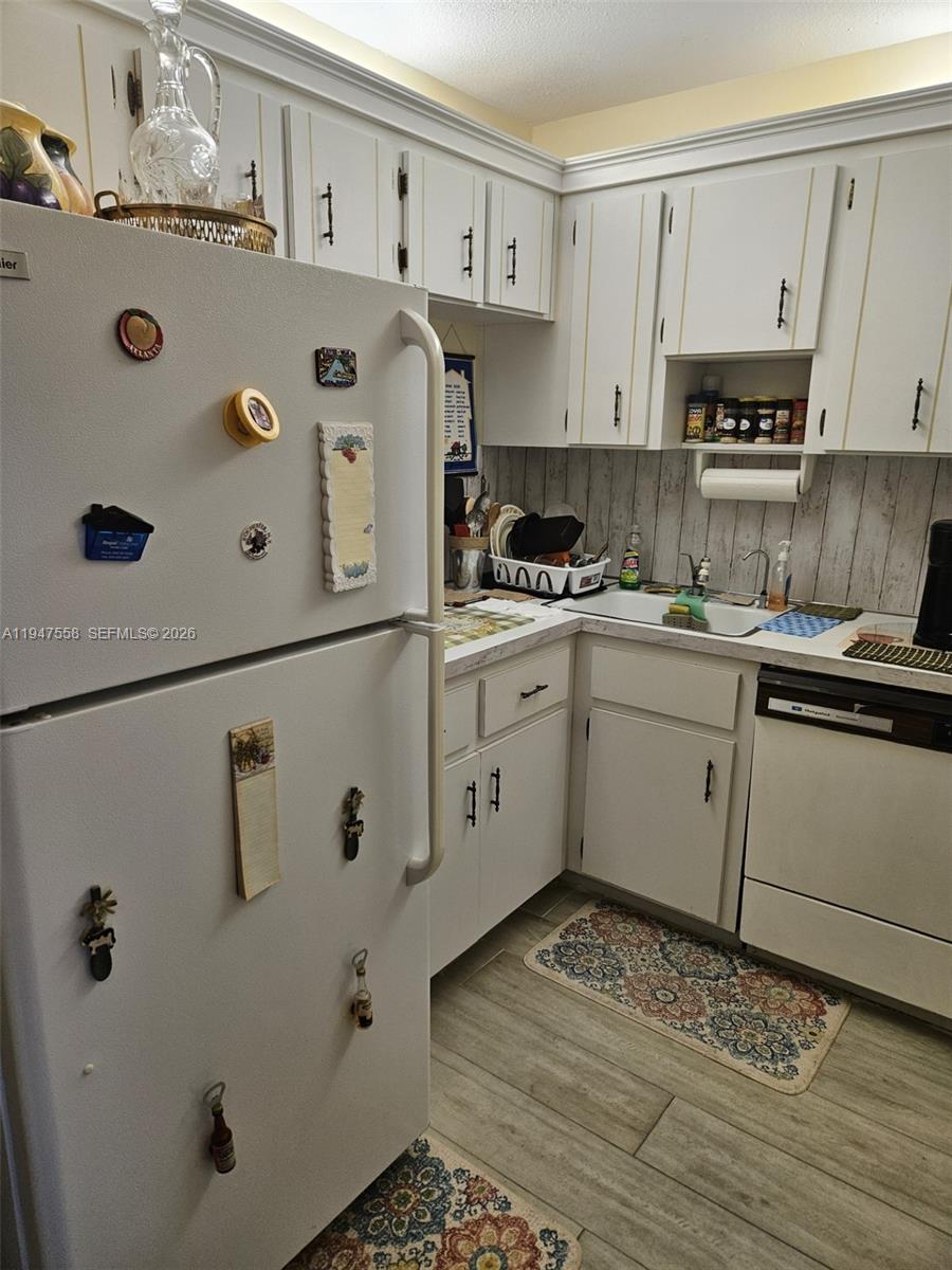 3591 Inverrary Drive, Unit 405 Lauderhill, FL 33319 - Photo 4 of 9 a kitchen with stainless steel appliances a refrigerator sink and cabinets