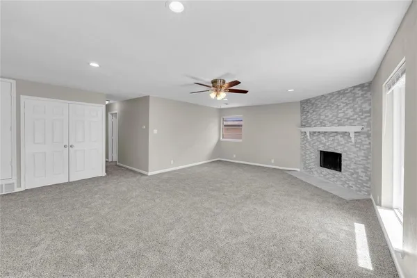 a view of empty room with a fireplace