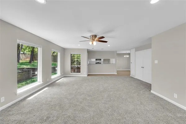 a view of a livingroom with a ceiling fan and window