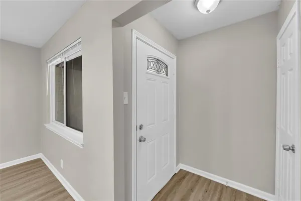 a view of a hallway with wooden floor