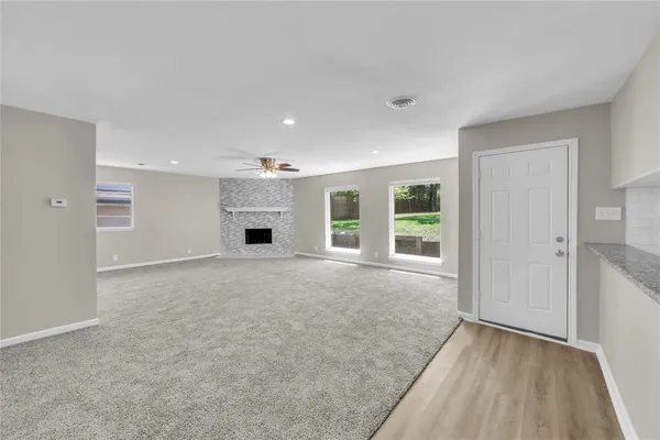 a view of a livingroom with a fireplace and a window