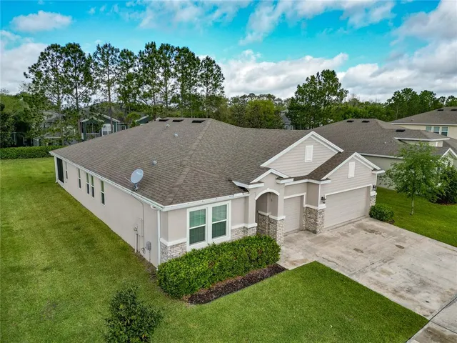 an aerial view of a house with a yard