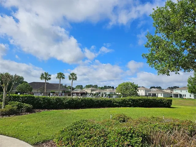 a view of a backyard with sitting area
