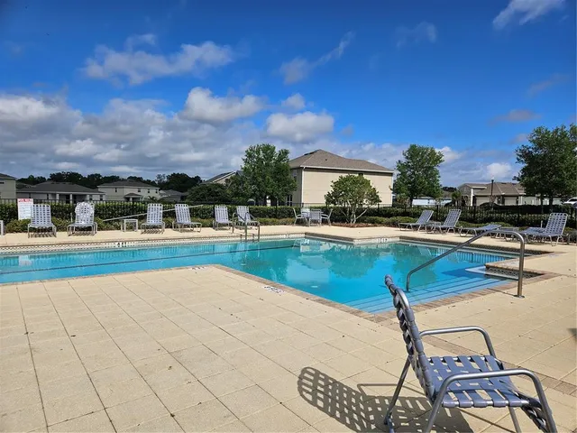 a view of a swimming pool and lounge chair