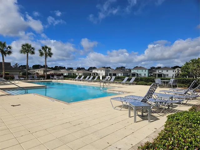 a bathroom with a granite countertop shower a mirror and a sink