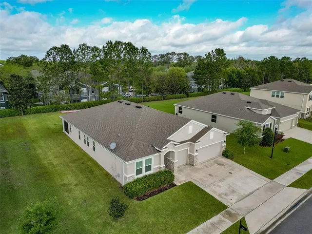an aerial view of a house with a yard