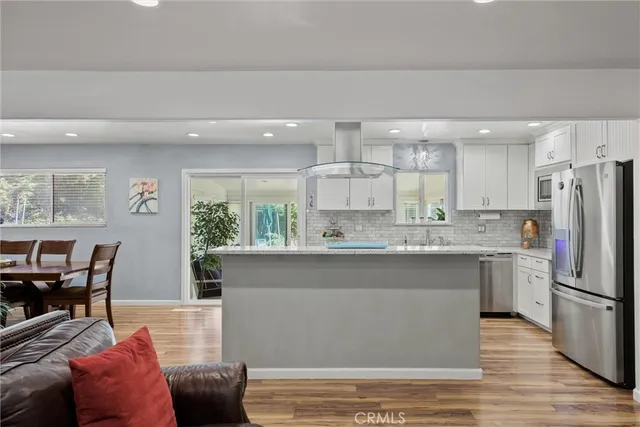 a kitchen with stainless steel appliances granite countertop a refrigerator sink and stove