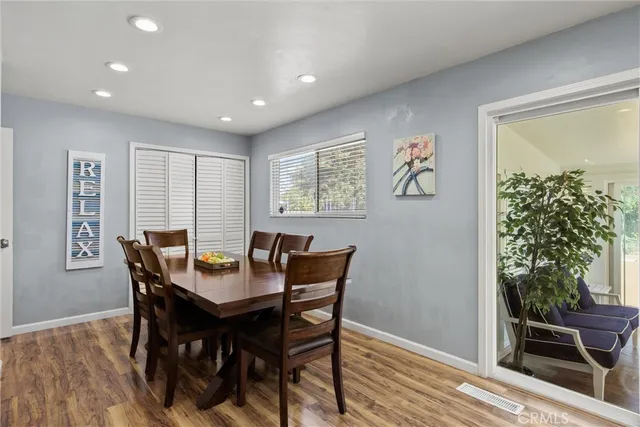 a view of a dining room with furniture window and wooden floor
