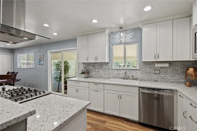 a kitchen with a sink stove and cabinets