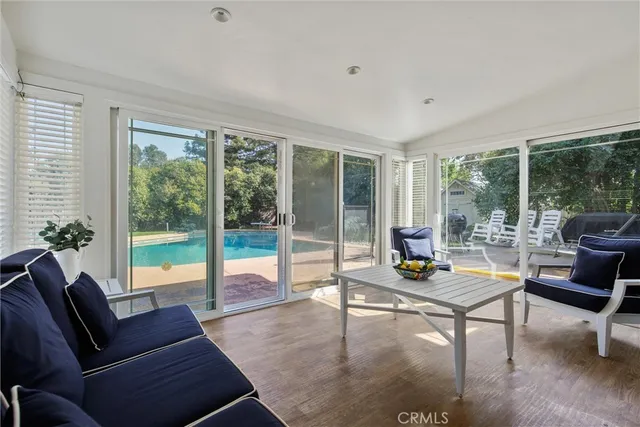 a living room with furniture and a floor to ceiling window