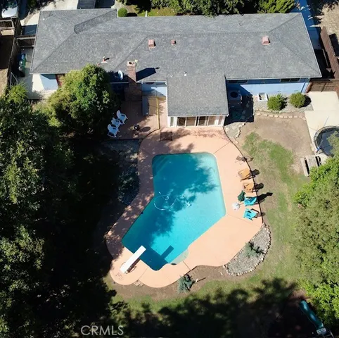 an aerial view of a house with a yard and a fountain