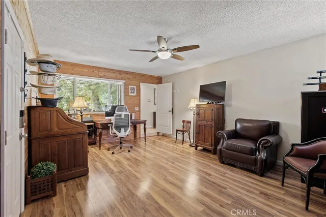 a living room with furniture a fireplace and a floor to ceiling window