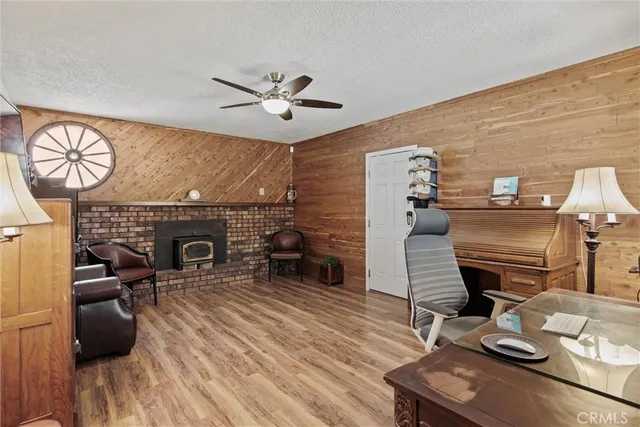 a living room with furniture a fireplace and wooden floor