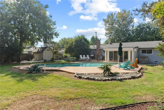 a front view of a house with swimming pool having outdoor seating