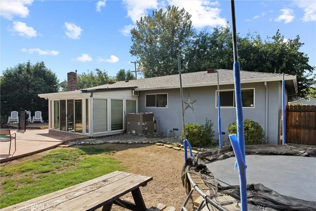 a view of a house with backyard sitting area and garden