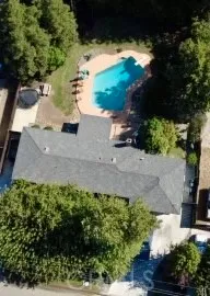 an aerial view of a house with a yard