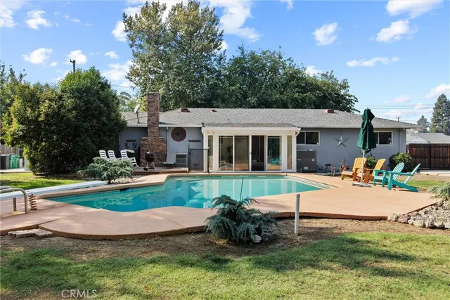 a view of a house with backyard porch and sitting area