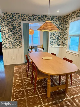 a view of a dining room with furniture and chandelier