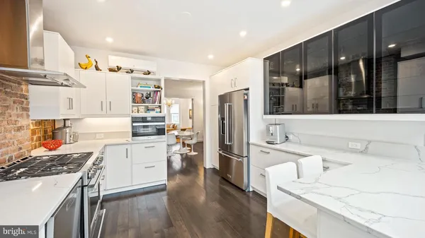 a kitchen with stainless steel appliances a stove a sink and a refrigerator
