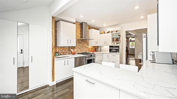 28 Bank Street Princeton, NJ 08542 - Photo 9 of 18 a large white kitchen with stainless steel appliances kitchen island granite countertop a refrigerator and cabinets