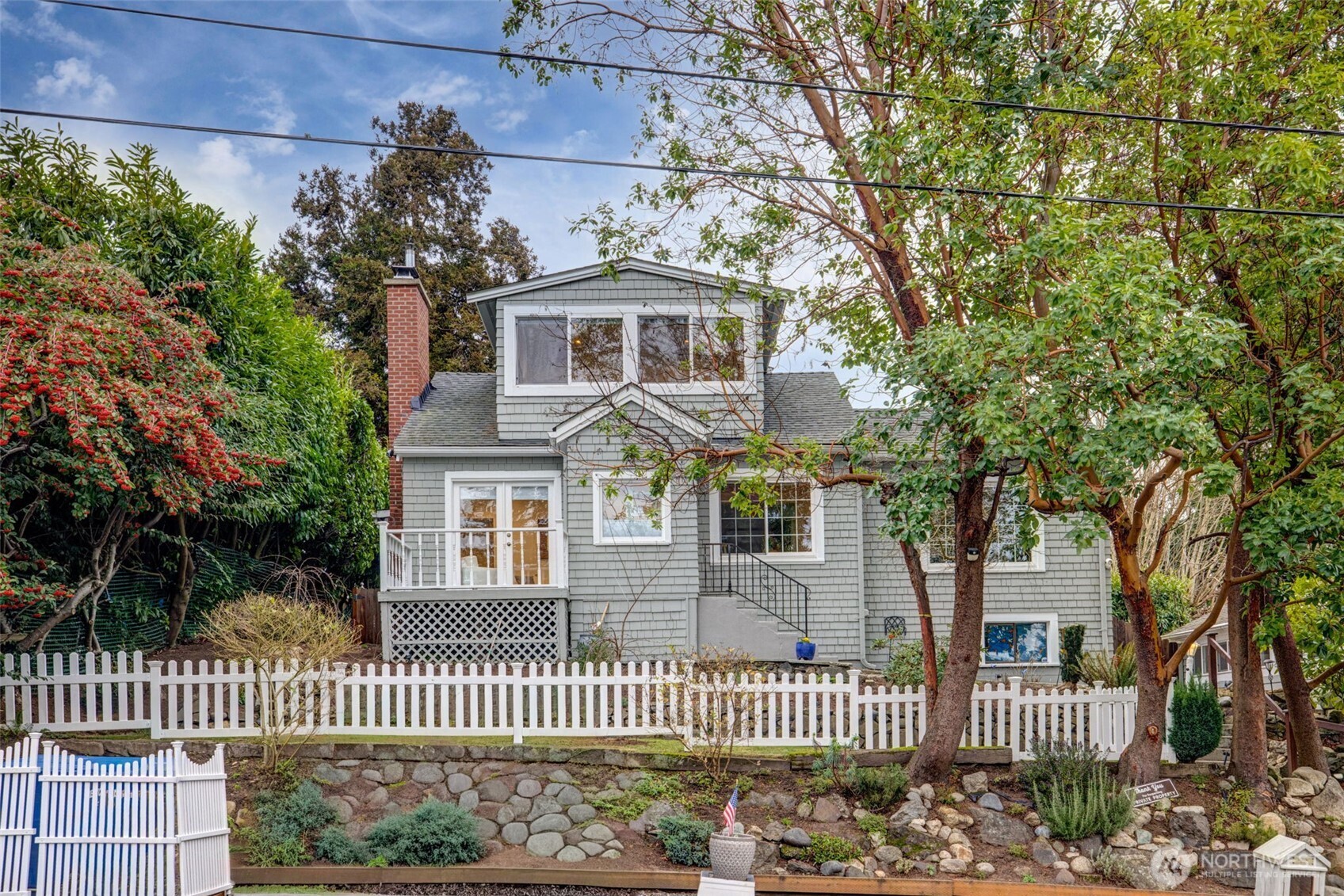 a front view of a house with a garden