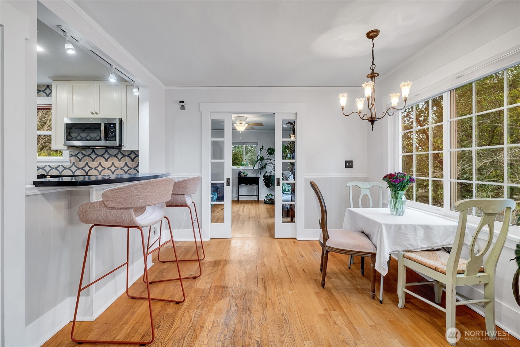 2726 50th Avenue Southwest Seattle, WA 98116 - Photo 13 of 40 a dining room with furniture a chandelier and wooden floor