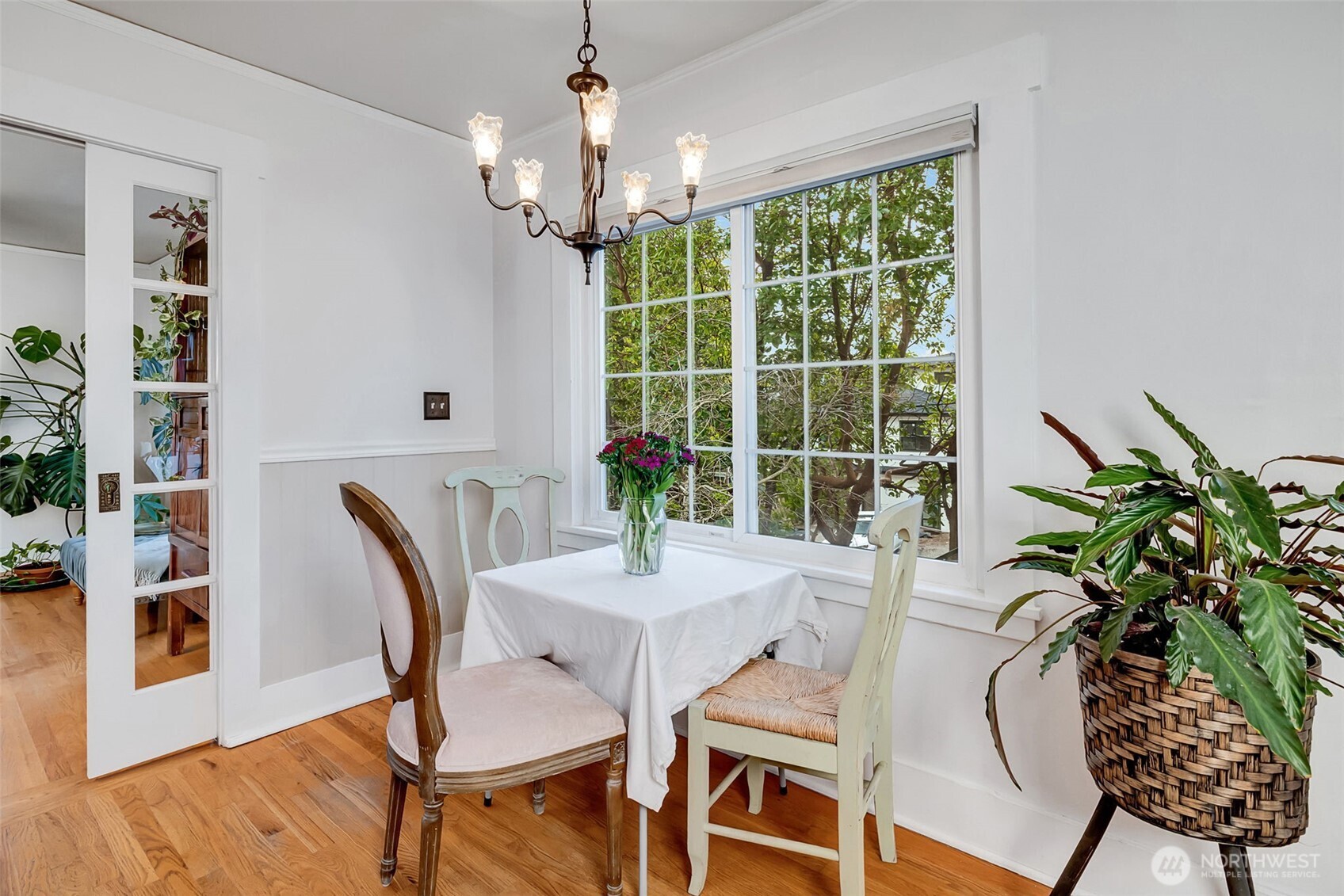 2726 50th Avenue Southwest Seattle, WA 98116 - Photo 16 of 40 a view of a dining room with furniture window and wooden floor