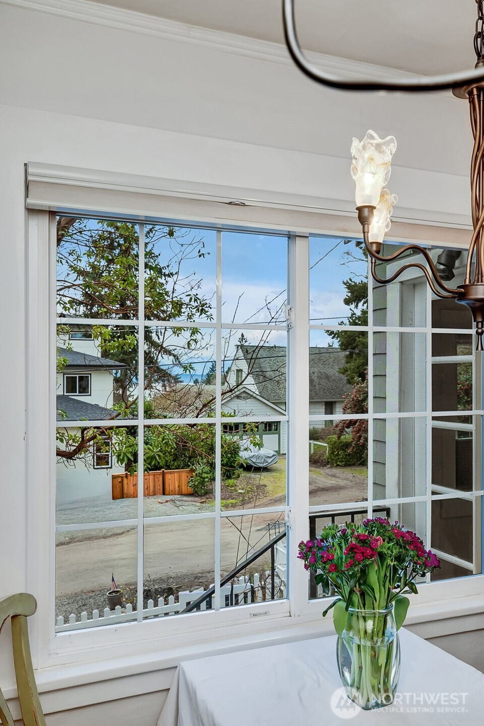 2726 50th Avenue Southwest Seattle, WA 98116 - Photo 17 of 40 a view of a glass door with a potted plant on a table