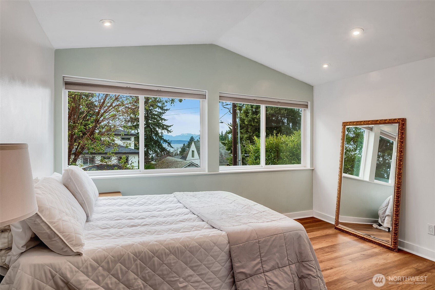2726 50th Avenue Southwest Seattle, WA 98116 - Photo 22 of 40 a bedroom with a large bed and a large window