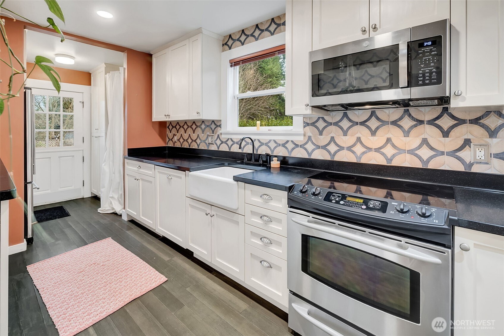 2726 50th Avenue Southwest Seattle, WA 98116 - Photo 26 of 40 a kitchen with stainless steel appliances a stove a sink and a microwave