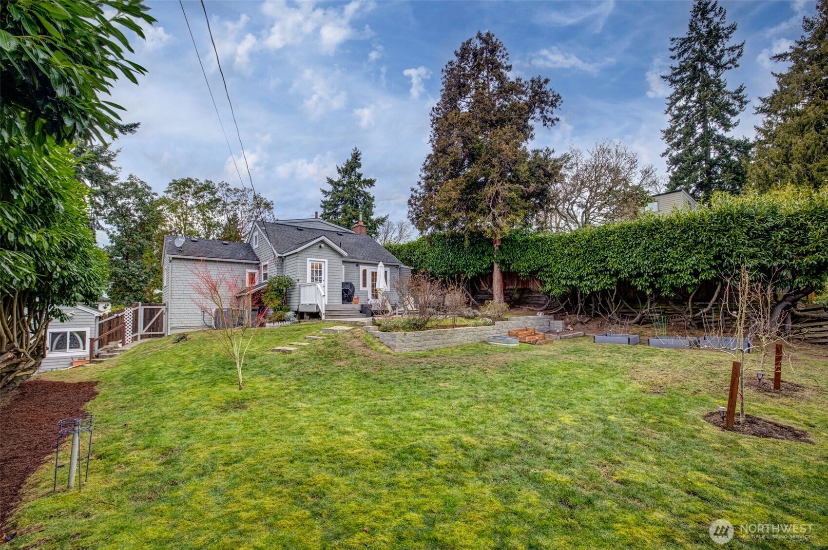 2726 50th Avenue Southwest Seattle, WA 98116 - Photo 35 of 40 a view of a house with a yard