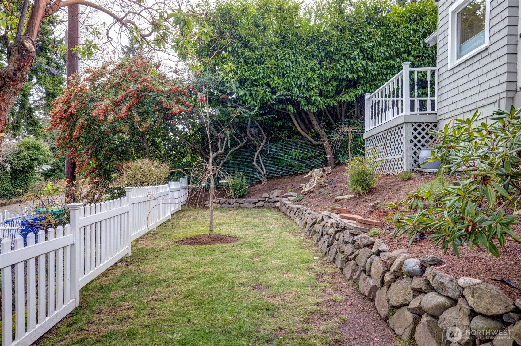 2726 50th Avenue Southwest Seattle, WA 98116 - Photo 4 of 40 a view of a house with backyard and trees