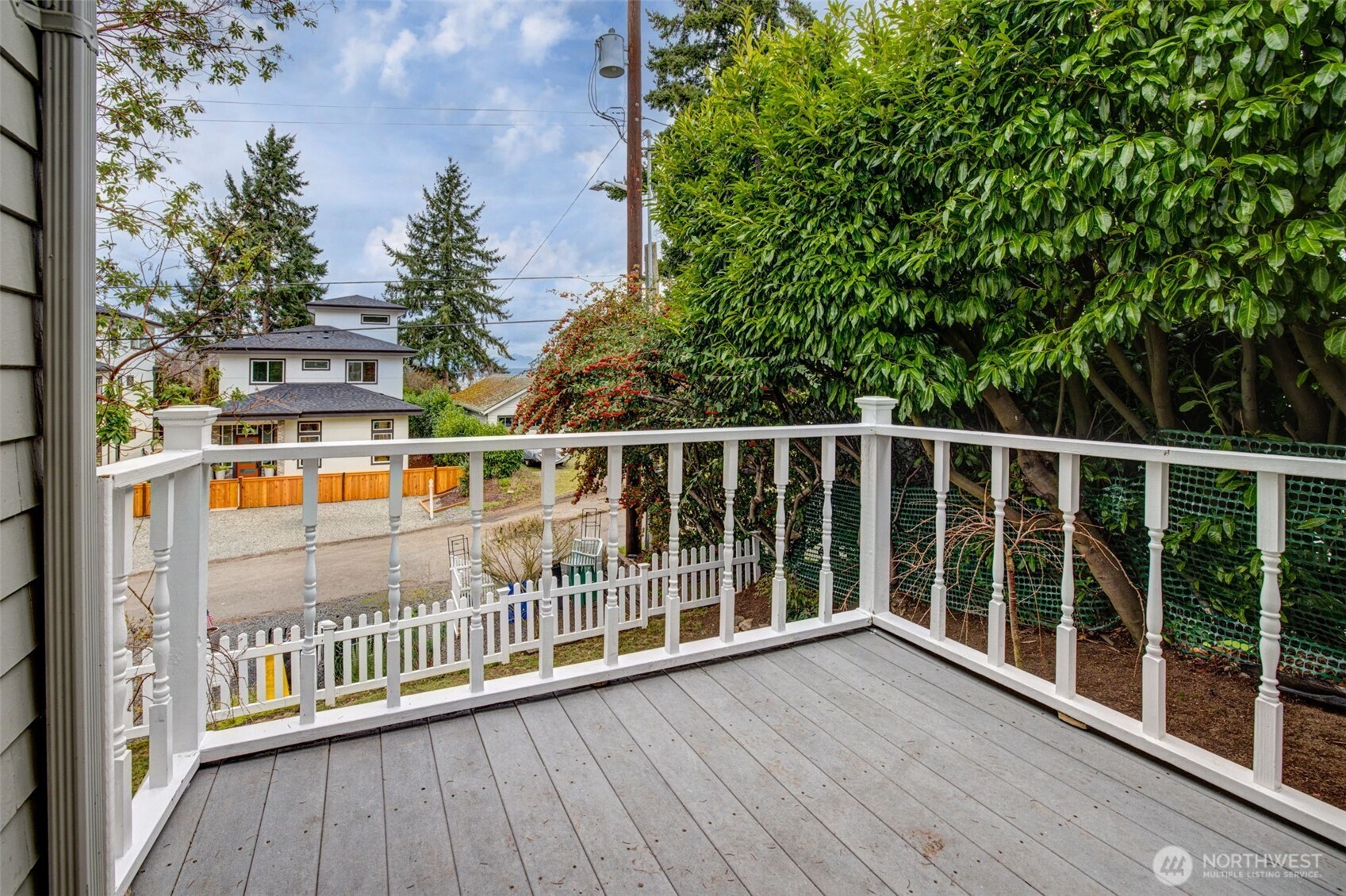 2726 50th Avenue Southwest Seattle, WA 98116 - Photo 10 of 40 a view of a balcony with a floor to ceiling window and wooden fence