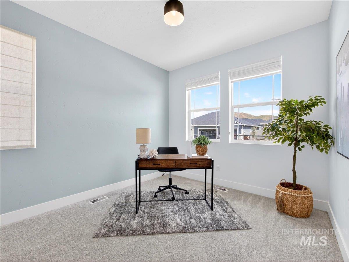 1811 Rome Avenue Emmett, ID 83617 - Photo 22 of 50 Room featuring light blue walls, light gray carpeting, and white baseboards
