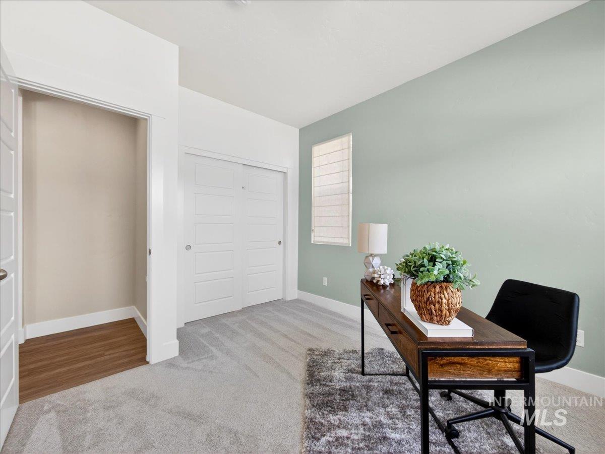 1811 Rome Avenue Emmett, ID 83617 - Photo 23 of 50 Room featuring a light green accent wall, light gray carpet, and white baseboards