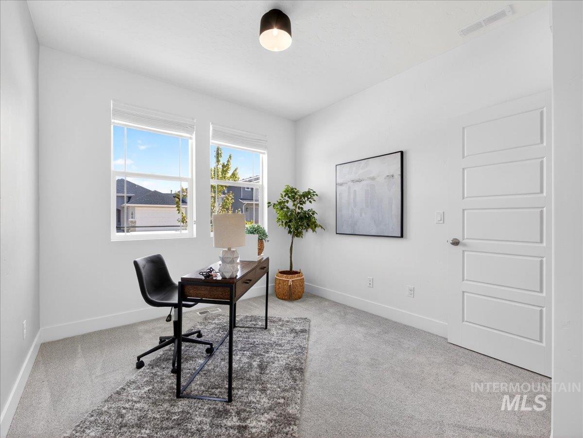 1811 Rome Avenue Emmett, ID 83617 - Photo 24 of 50 Bright room with light grey carpet, white walls, and a modern five-panel interior door