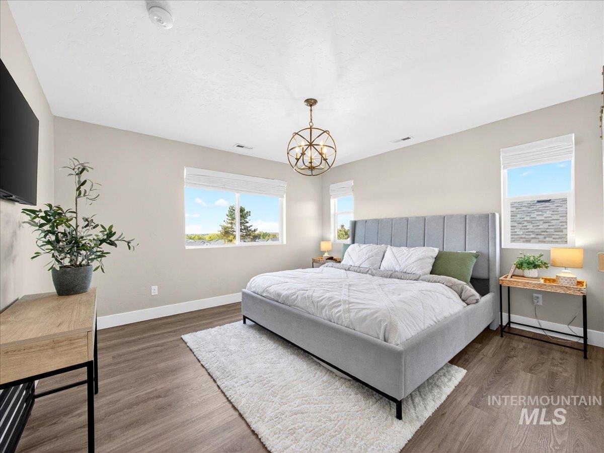 1811 Rome Avenue Emmett, ID 83617 - Photo 26 of 50 Spacious room featuring wood-finish flooring, light-toned walls, and multiple windows with white blinds