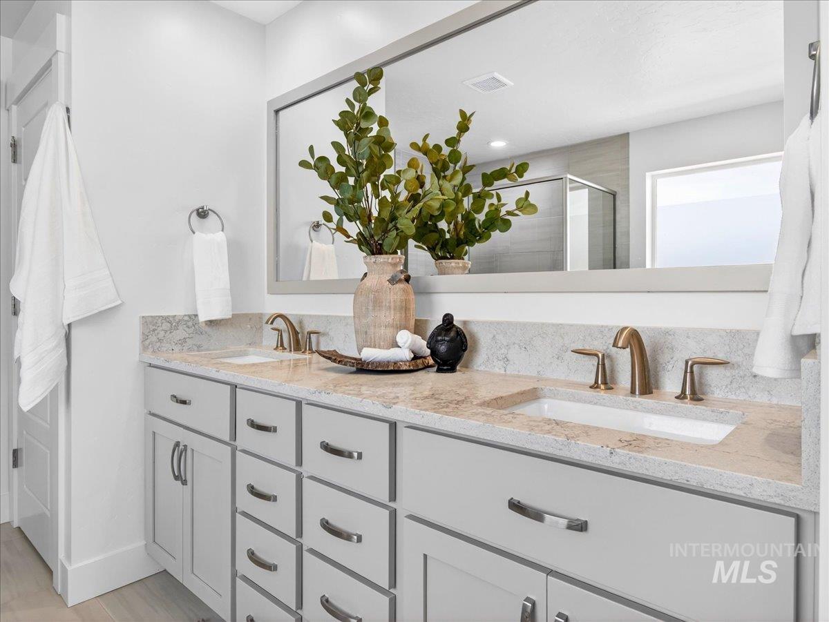 1811 Rome Avenue Emmett, ID 83617 - Photo 32 of 50 Dual vanity with light gray cabinetry and brushed brass fixtures