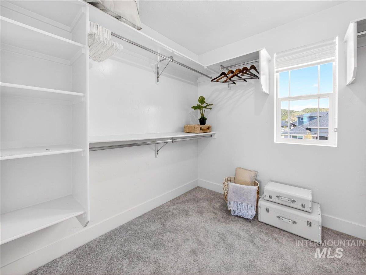 1811 Rome Avenue Emmett, ID 83617 - Photo 34 of 50 Spacious walk-in closet featuring built-in shelving, multiple hanging rods, and a double-hung window