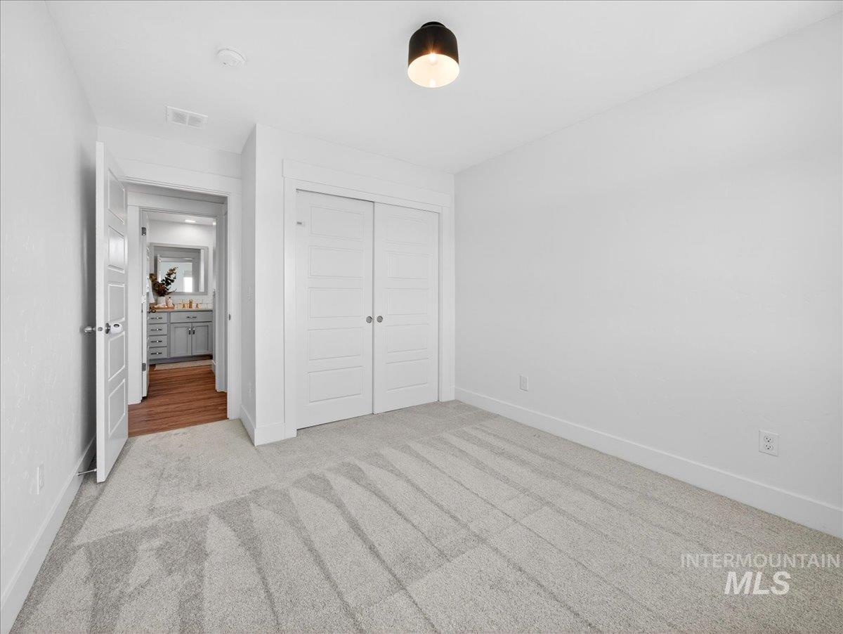 1811 Rome Avenue Emmett, ID 83617 - Photo 38 of 50 Carpeted room featuring a modern flush-mount ceiling light, white walls, and white baseboards