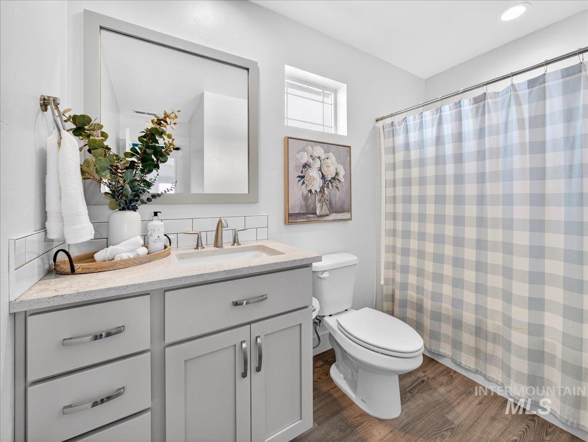 1811 Rome Avenue Emmett, ID 83617 - Photo 39 of 50 Full bathroom featuring a single vanity with light grey cabinetry and brushed nickel hardware, a rectangular undermount sink, and a light-toned countertop