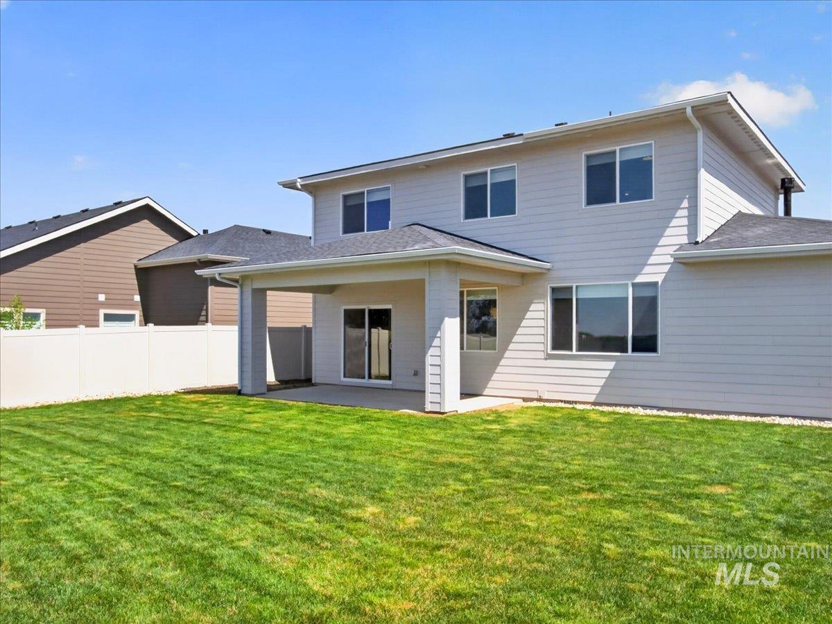 1811 Rome Avenue Emmett, ID 83617 - Photo 43 of 50 Spacious backyard featuring a manicured lawn, white vinyl fencing, and a covered patio