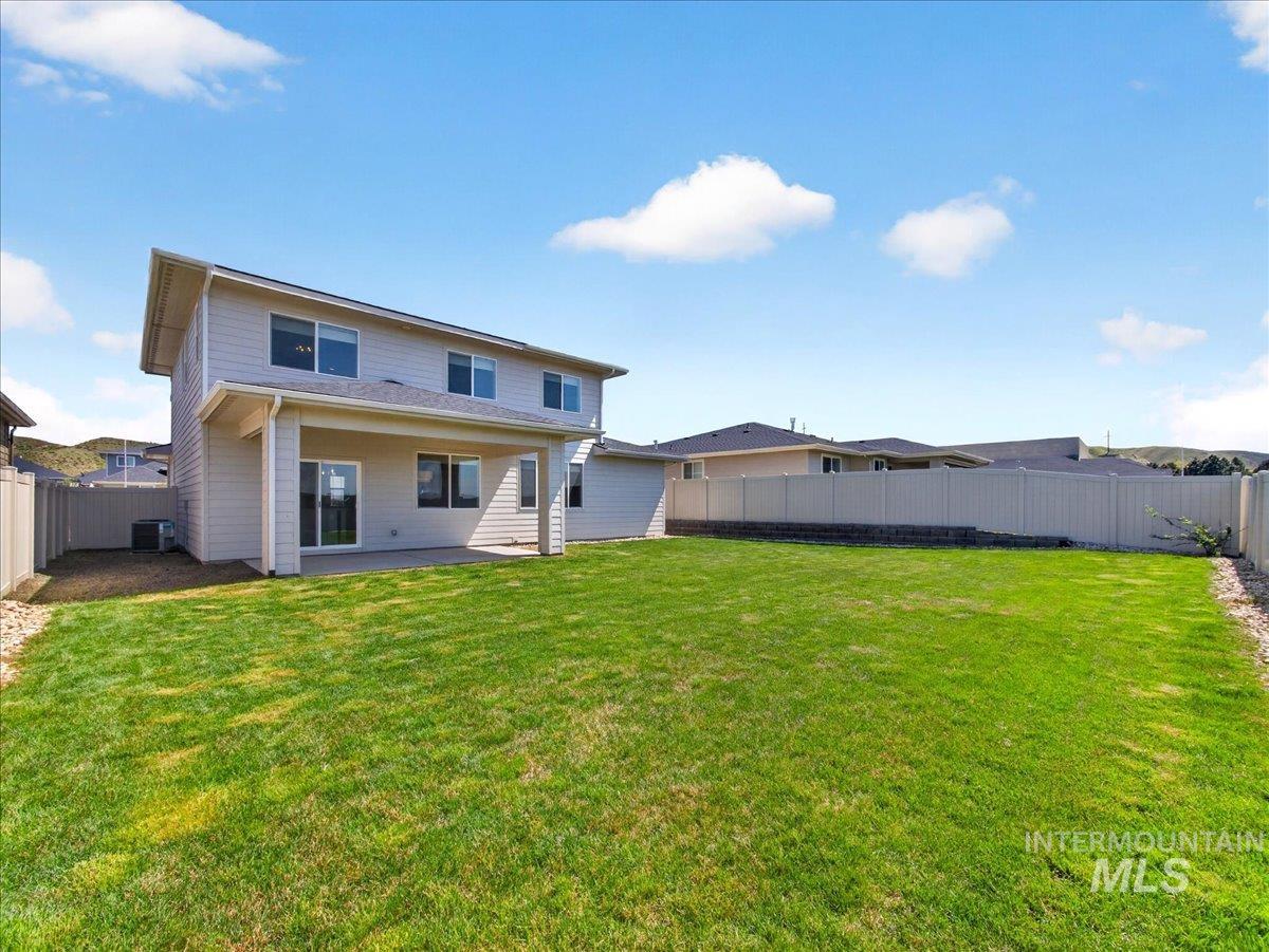 1811 Rome Avenue Emmett, ID 83617 - Photo 45 of 50 Expansive fenced backyard featuring a large green lawn, a covered patio, and a concrete patio slab