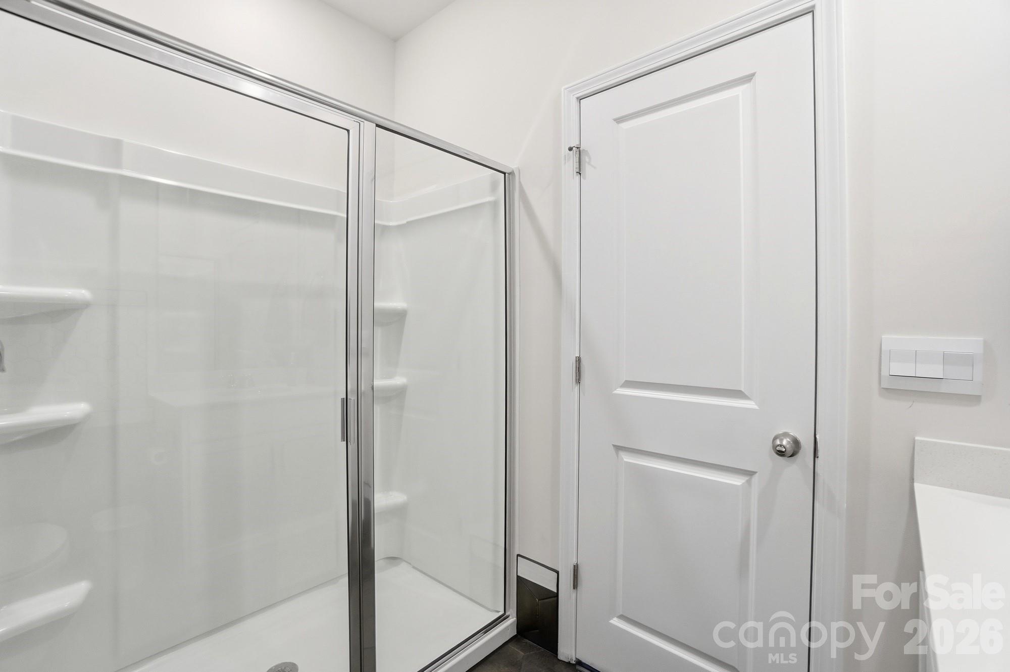 116 Timbergreen Court Troutman, NC 28166 - Photo 32 of 43 a bathroom with a glass shower door