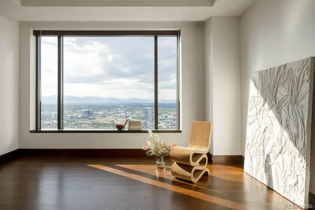 a view of a balcony with a chair and a floor to ceiling window