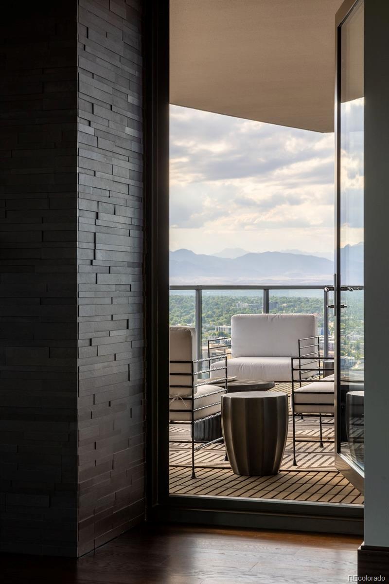 1133 14th Street, Unit 3700 Denver, CO 80202 - Photo 18 of 48 a view of a balcony with a chair and a floor to ceiling window