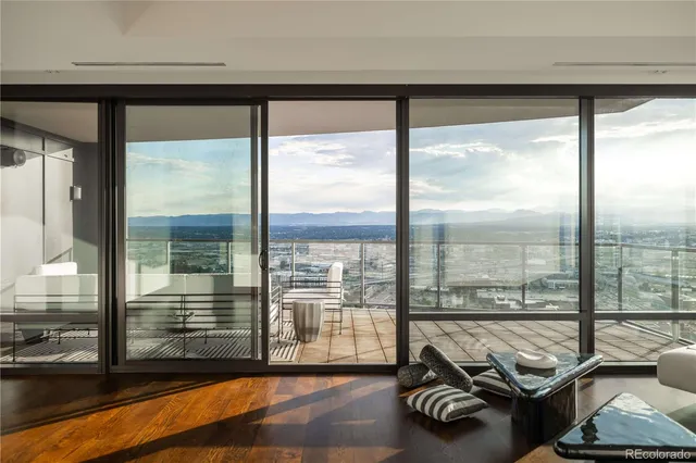 a room with furniture and a floor to ceiling window